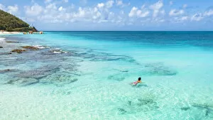 Beautiful woman enjoying swimming in the crystal Caribbean Sea, Antigua, Antigua and Barbuda, Leeward Islands