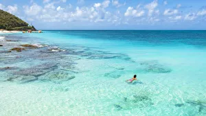 Beautiful woman enjoying swimming in the crystal Caribbean Sea, Antigua, Antigua and Barbuda, Leeward Islands, West Indies, Caribbean, Central America Beautiful woman enjoying swimming in the crystal Caribbean Sea, Antigua, Antigua and Barbuda, Leeward Islands, West Indies, Caribbean, Central America