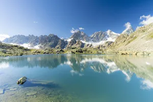 Bernina Group mountains mirrored in the clear water of Forbici lake, Valmalenco Bernina Group mountains mirrored in the clear water of Forbici lake, Valmalenco