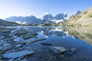 Bernina Group reflected in the clear water of Forbici lake at dawn, Valmalenco Bernina Group reflected in the clear water of Forbici lake at dawn, Valmalenco