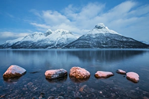 Blue sky at dusk and snowy peaks are reflected in the frozen sea, Storfjorden, Lapland Blue sky at dusk and snowy peaks are reflected in the frozen sea, Storfjorden, Lapland