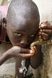 Boy drinking water, Dakar, Senegal, West Africa, Africa