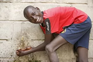 Images Dated 9th December 2008: Boy washing hands, Dakar, Senegal, West Africa, Africa