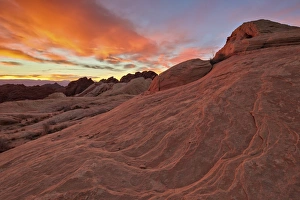 Brilliant orange clouds at sunrise over sandstone, Valley Of Fire State Park, Nevada Brilliant orange clouds at sunrise over sandstone, Valley Of Fire State Park, Nevada