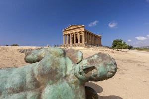 Bronze statue of the fallen Icarus frames the ancient Temple of Concordia Bronze statue of the fallen Icarus frames the ancient Temple of Concordia