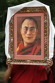 Images Dated 22nd September 2007: Buddhist holding a picture of the Dalai Lama, Paris, Ile de France, France, Europe