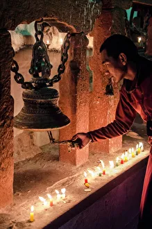 A Buddhist monk rings a prayer bell during the full moon celebrations, Bodhnath stupa A Buddhist monk rings a prayer bell during the full moon celebrations, Bodhnath stupa