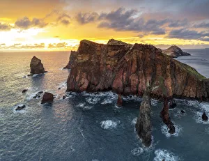 Burning sky at dawn on cliffs washed by ocean, Ponta do Rosto viewpoint Burning sky at dawn on cliffs washed by ocean, Ponta do Rosto viewpoint