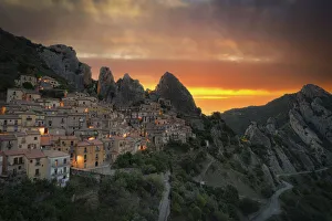 Burning sky at sunrise over the old houses of Castelmezzano and Dolomiti Lucane mountains Burning sky at sunrise over the old houses of Castelmezzano and Dolomiti Lucane mountains