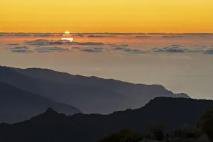 Burning sky at sunset over the Atlantic Ocean and silhouettes of mountains from Pico Burning sky at sunset over the Atlantic Ocean and silhouettes of mountains from Pico