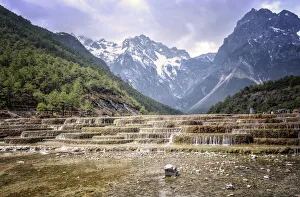 Cascading falls at Baishuihe with Jade Dragon Snow Mountain backdrop, Lijiang, Yunnan, China, Asia Cascading falls at Baishuihe with Jade Dragon Snow Mountain backdrop, Lijiang, Yunnan, China, Asia