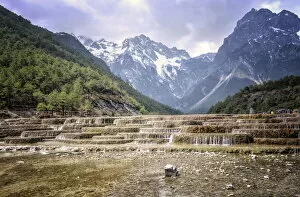 Images Dated 11th March 2014: Cascading falls at Baishuihe with Jade Dragon Snow Mountain backdrop, Lijiang, Yunnan, China, Asia