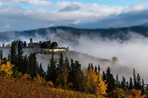Castello di Colognole as sun breaks through early morning mist, Greve in Chianti, Tuscany Castello di Colognole as sun breaks through early morning mist, Greve in Chianti, Tuscany
