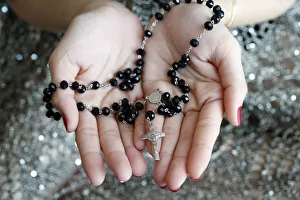 Catholic woman praying rosary beads and crucifix, Vietnam, Indochina, Southeast Asia Catholic woman praying rosary beads and crucifix, Vietnam, Indochina, Southeast Asia