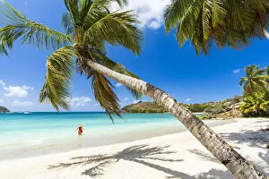 Cheerful woman sunbathing in the crystal Caribbean sea, Antigua, Leeward Islands, West Indies, Caribbean