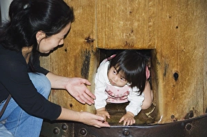 Child crawling though hole in wooden column to reach Nirvana Child crawling though hole in wooden column to reach Nirvana