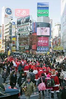 Santa Claus Gallery: Christmas Santas walking across Shibuya crossing, Shibuya ward, Tokyo, Japan, Asia
