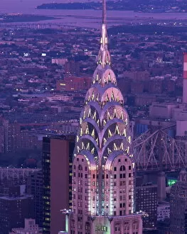 America Gallery: The top of the Chrysler Building illuminated in the evening with a bridge