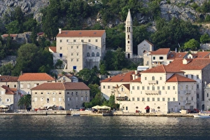 Church of Our Lady of the Rosary and a waterside restaurant lit by evening light, Perast Church of Our Lady of the Rosary and a waterside restaurant lit by evening light, Perast