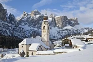 Buda Gallery: The church and village of Colfosco in Badia, 1645, and Sella Massif range of mountains under winter snow