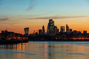 The City of London skyline at sunset reflecting in River Thames, London, England, United Kingdom, Europe The City of London skyline at sunset reflecting in River Thames, London, England, United Kingdom, Europe