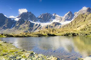 Clear sky over the rocky peaks of Bernina Group and Forbici lake in summer, Valmalenco Clear sky over the rocky peaks of Bernina Group and Forbici lake in summer, Valmalenco