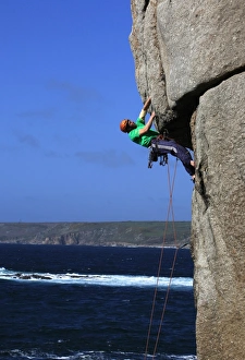 A climber tackles a difficult overhang on the cliffs near Sennen Cove A climber tackles a difficult overhang on the cliffs near Sennen Cove