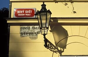 Close-up of current and historical street signs with lamp on a wall, Hradcany