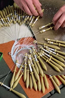 Textile Gallery: Close-up of hands and bobbins for lace making at Le Puy in the Auvergne, France, Europe