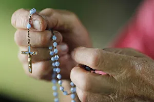 Close-up of a man's hands praying the rosary, France, Europe Close-up of a man's hands praying the rosary, France, Europe