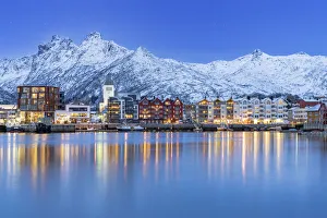 Coastal town of Svolvaer framed by snowcapped mountains at dusk, Nordland county, Lofoten Islands, Norway, Scandinavia Coastal town of Svolvaer framed by snowcapped mountains at dusk, Nordland county, Lofoten Islands, Norway, Scandinavia