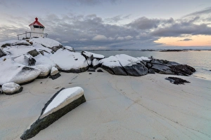 Colorful arctic sunset on the lighthouse surrounded by snow and icy sand, Eggum, Vestvagoy Colorful arctic sunset on the lighthouse surrounded by snow and icy sand, Eggum, Vestvagoy