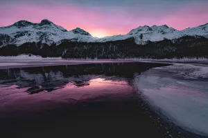 Colorful sky at sunrise on snowcapped mountains and frozen Lake Silvaplana, Maloja Colorful sky at sunrise on snowcapped mountains and frozen Lake Silvaplana, Maloja