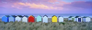 English Culture Gallery: Colourful beach huts and sand dunes at sunset, Southwold, Suffolk, England, United Kingdom