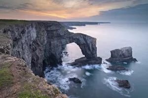 Welsh Culture Collection: Colourful dawn sky above the Green Bridge of Wales natural arch in Pembrokeshire, Wales