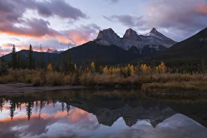 Colourful sunrise over Three Sisters at Policeman Creek in autumn, Canmore, Banff Colourful sunrise over Three Sisters at Policeman Creek in autumn, Canmore, Banff