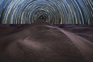 Concentric circumpolar star trail above sand dunes in the Rub al Khali desert, Oman Concentric circumpolar star trail above sand dunes in the Rub al Khali desert, Oman