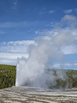 The cone geyser called Old Faithful erupting, Yellowstone National Park The cone geyser called Old Faithful erupting, Yellowstone National Park
