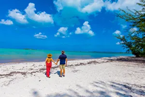 Couple enjoying the white sands and epic ocean view of Horse Stable Beach, North Caicos Couple enjoying the white sands and epic ocean view of Horse Stable Beach, North Caicos