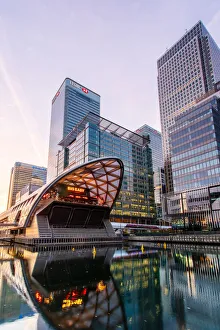 Crossrail station and office buildings reflecting in dock before sunrise, Canary Wharf, Docklands, London, England Crossrail station and office buildings reflecting in dock before sunrise, Canary Wharf, Docklands, London, England