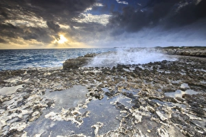 Devils Bridge, a natural arch carved by the sea from soft and hard limestone ledges Devils Bridge, a natural arch carved by the sea from soft and hard limestone ledges