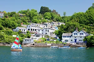A dinghy sails past the village of Boddinick near Fowey, Cornwall, England, United Kingdom, Europe A dinghy sails past the village of Boddinick near Fowey, Cornwall, England, United Kingdom, Europe