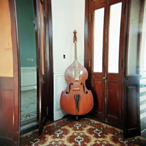 Double bass propped against a wall, Cienfuegos, Cuba, West Indies, Central America
