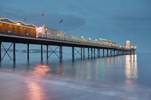 South West England Landmarks Prints: A dusk view of a classic seaside pier, Paignton Pier, Torbay, Devon, England
