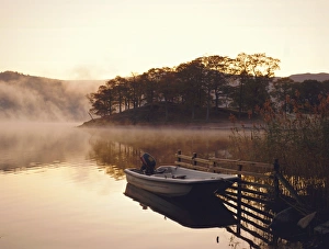 Early morning mist and boat, Derwent Water, Lake District, Cumbria, England Early morning mist and boat, Derwent Water, Lake District, Cumbria, England
