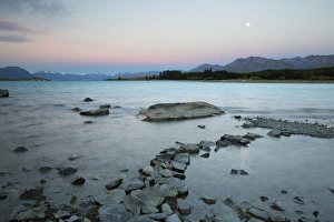 Edge of lake at dusk, Lake Tekapo, Canterbury region, South Island, New Zealand, Pacific Edge of lake at dusk, Lake Tekapo, Canterbury region, South Island, New Zealand, Pacific