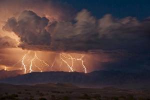 Electrical storm with forked lightning over the Grapevine mountains of the Amargosa Range Electrical storm with forked lightning over the Grapevine mountains of the Amargosa Range