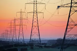 Electricity pylons at daybreak, Derbyshire/Nottinghamshire border, England, United Kingdom, Europe