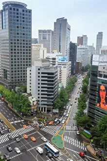 Elevated view of a busy city centre street and high rise buildings on a rainy summer day
