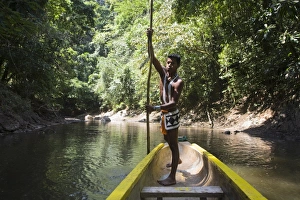 Embera Indian man in dugout canoe on Chagres River, Panama, Central America Embera Indian man in dugout canoe on Chagres River, Panama, Central America